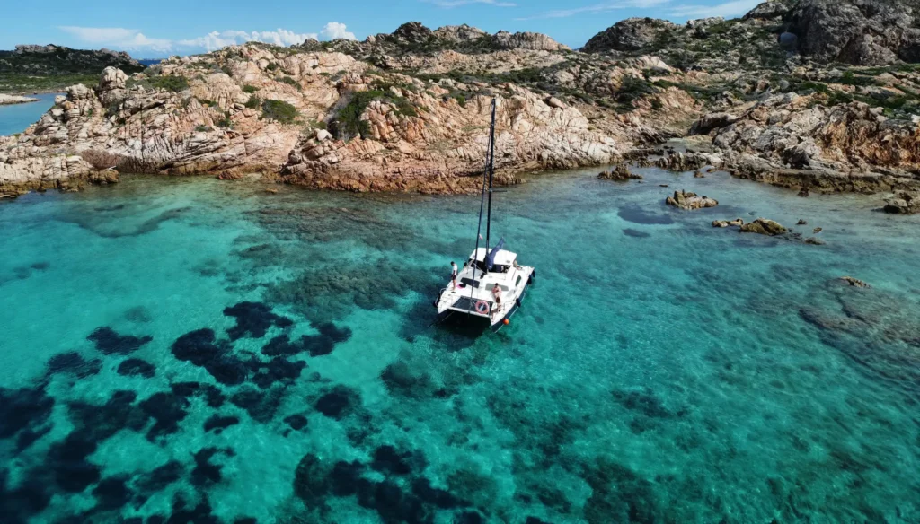Catamarano ancorato nella baia turchese di Cala Corsara, isola di Spargi